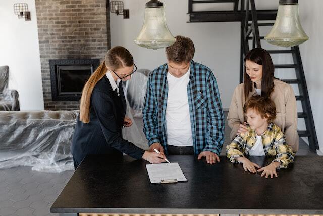 A property manager signing a lease agreement with a family of two adults and one child